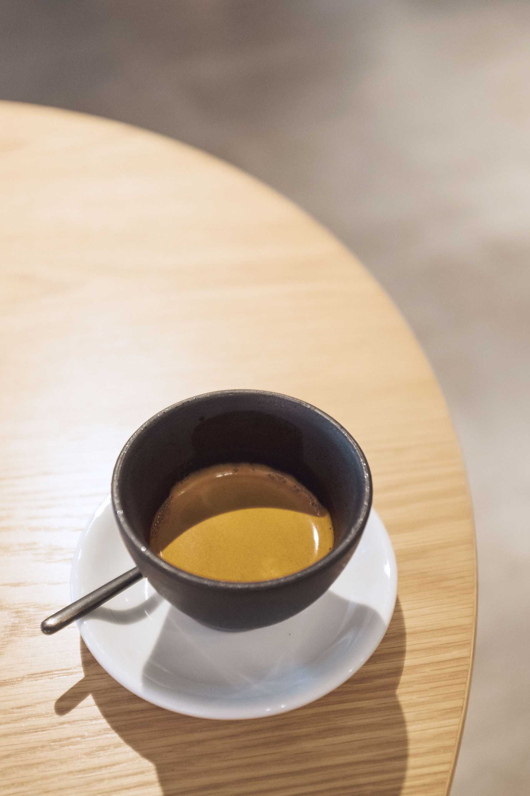 A barista at Arlo pouring Latte Art